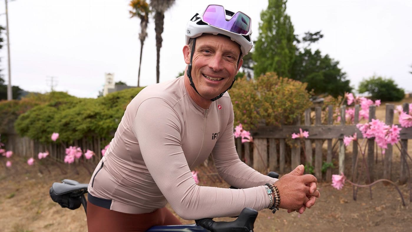 iFIT trainer Yuri Hauswald prepares for a cycling workout, representing the trainer-led endurance and cross-training sessions available through iFIT.